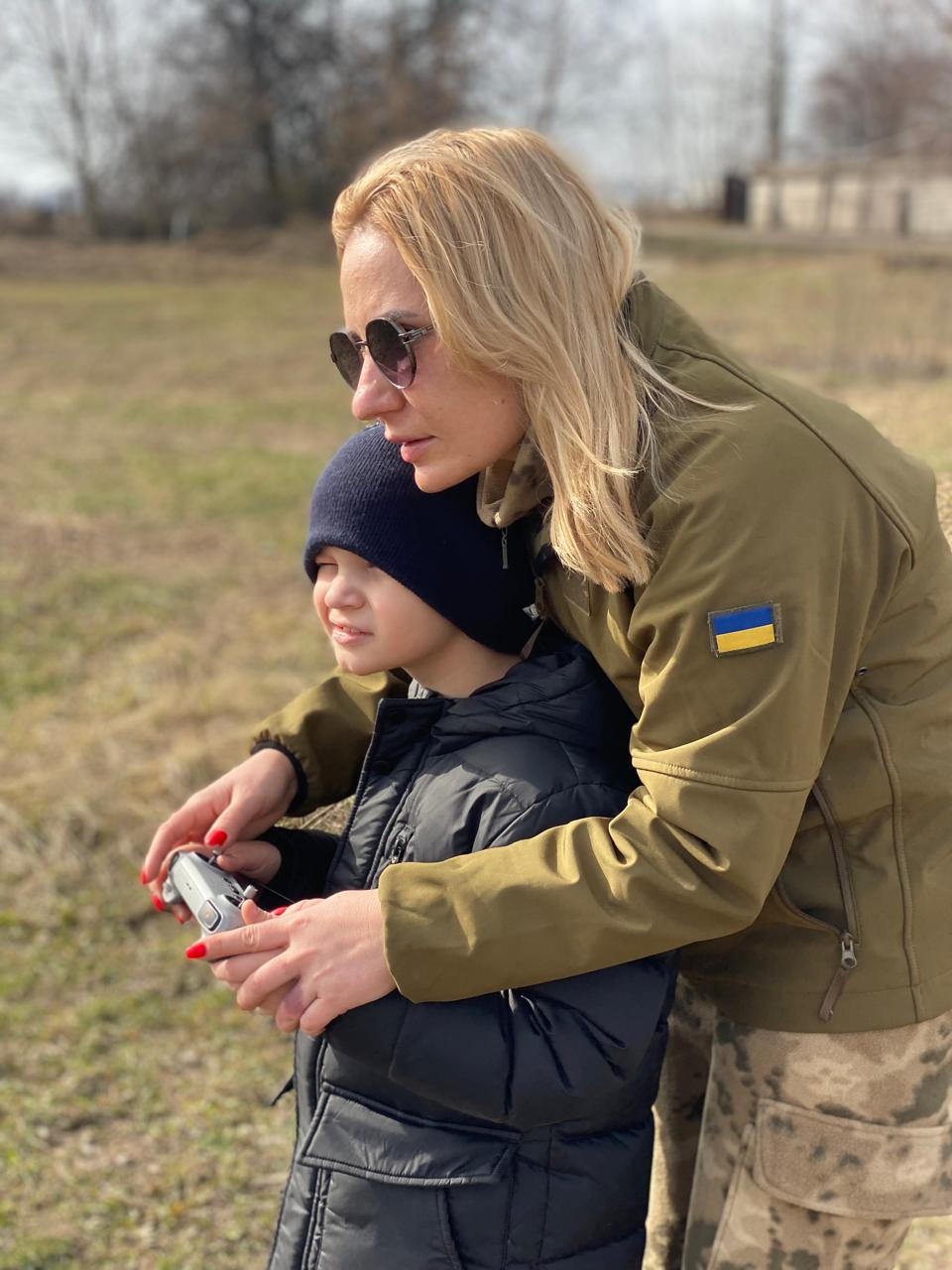 Savva outdoors with his mother