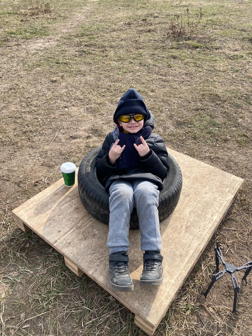 Savva smiling while seated outdoors