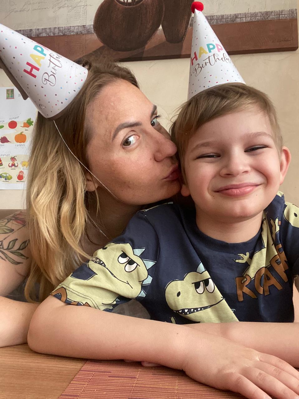 Savva smiling beside his mother during a birthday celebration